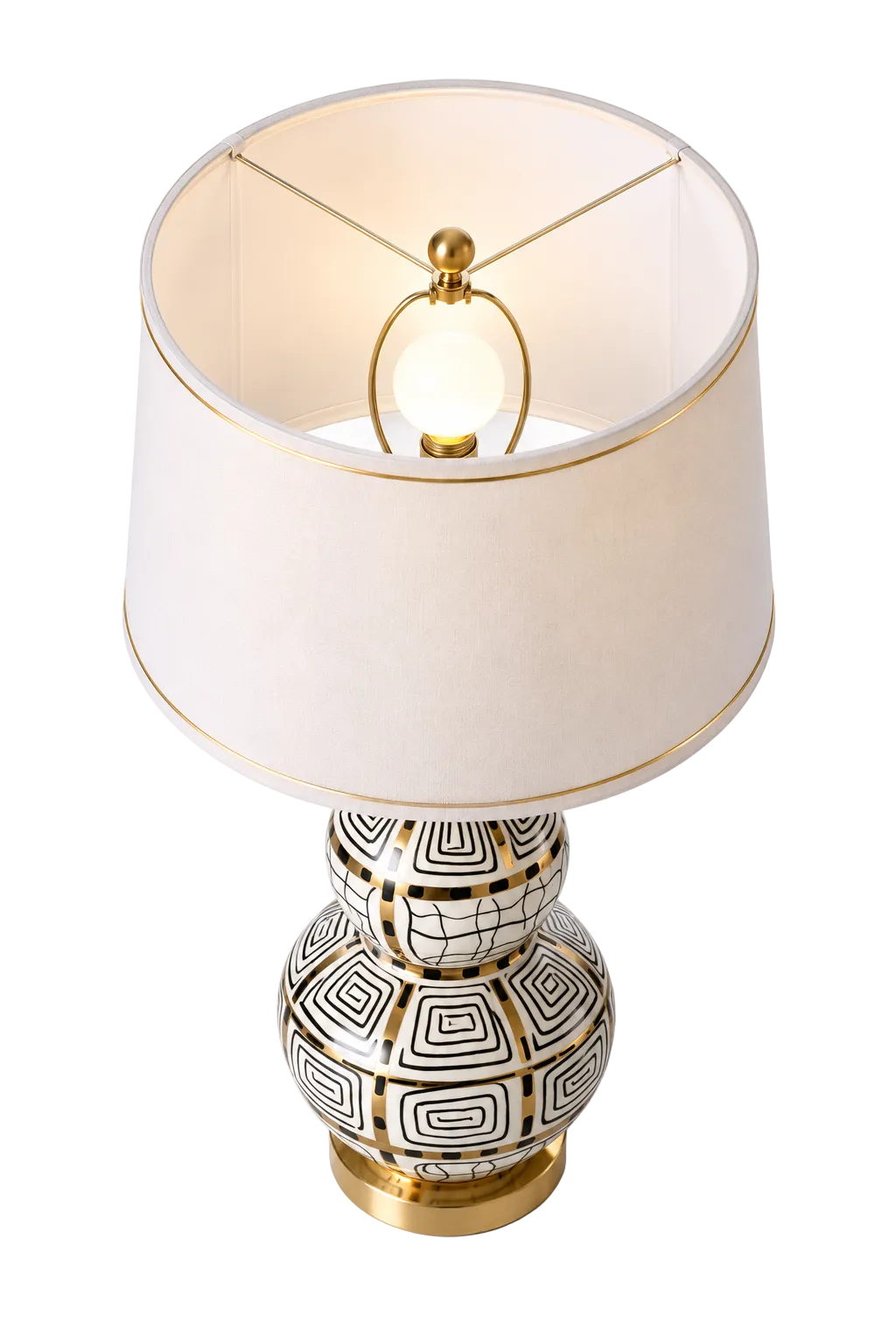 White, black and gold patterned table lamp with gold-trimmed shade