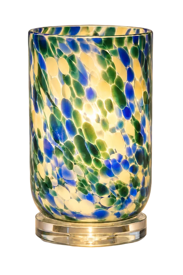 A tall cylindrical glass candle holder or lamp with a swirled pattern of blue, green, and yellow glass, sitting on a clear circular base against a neutral gray background.