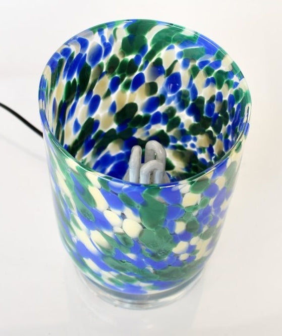Colorful glass container with a power cable on a white background