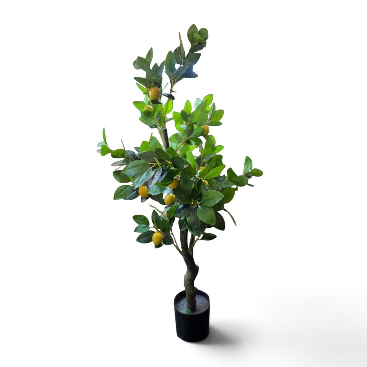 An artificial lemon tree with green leaves and yellow faux lemons, potted in a black plastic pot, shown against a plain white background.