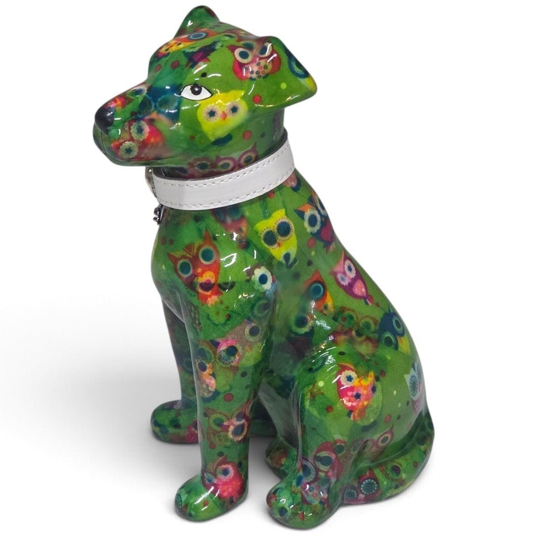 A glossy ceramic dog figurine in a sitting position, decorated with a vibrant green and multicolor mosaic tile pattern, featuring a white collar, set against a plain white background.