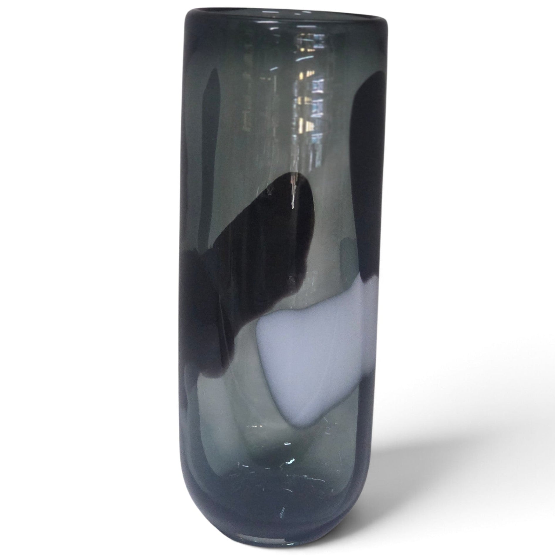 A tall, cylindrical glass vase with a smoky, translucent dark gray body and bold, organic black and white abstract swirls, set against a plain white background.