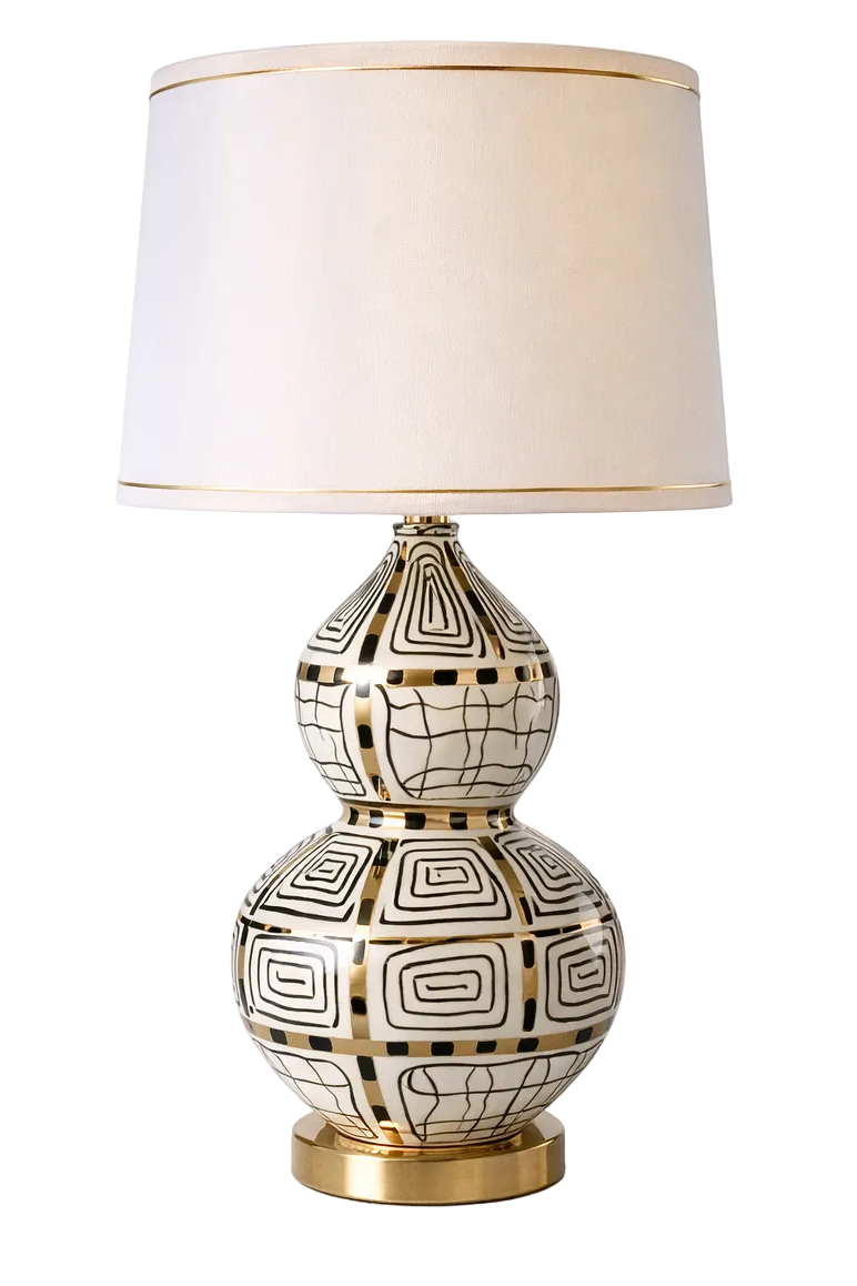 White, black and gold patterned table lamp with gold-trimmed shade